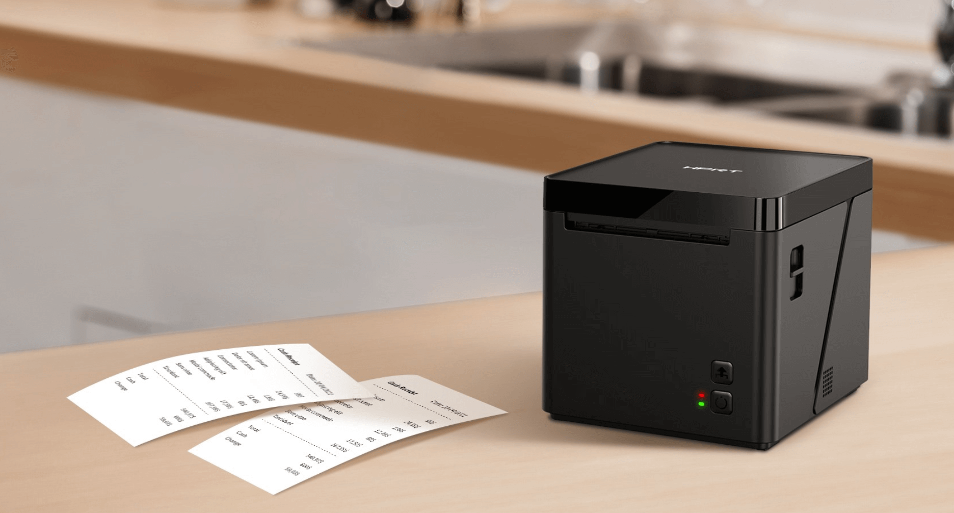 compact receipt printer on a counter with printed receipts beside it compact receipt printer on a counter with printed receipts beside it