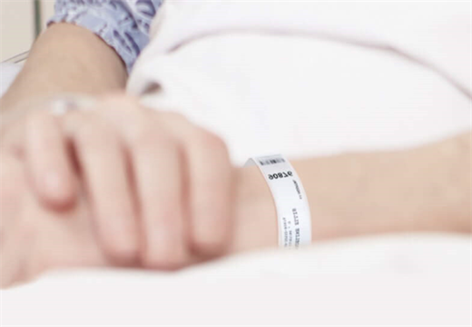 Patient wearing a barcode wristband for hospital identification and safety tracking Patient wearing a barcode wristband for hospital identification and safety tracking